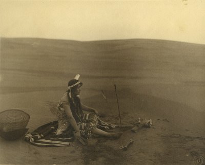 A seated Native American woman by American Photographer